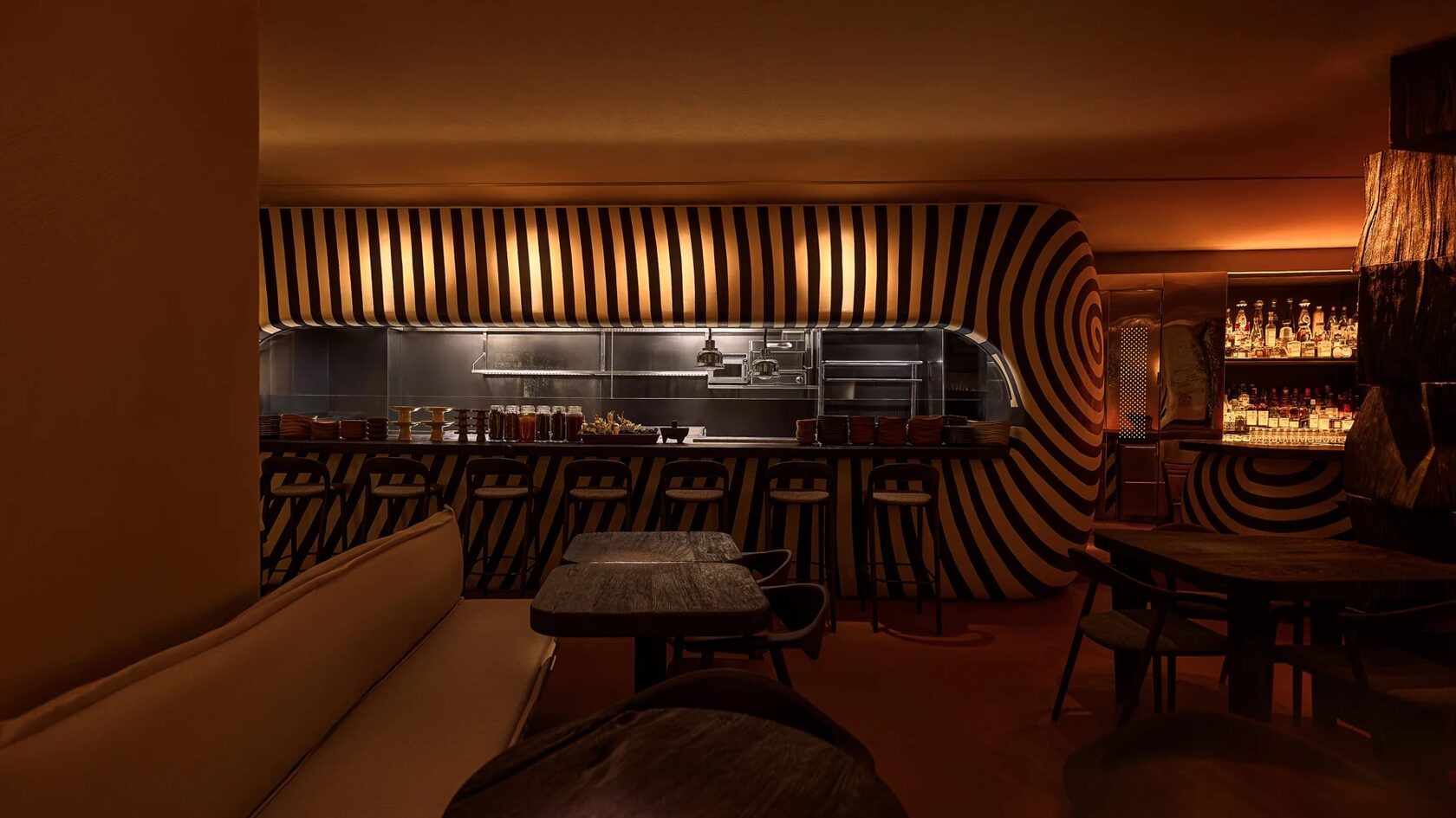 SOBREMESA's striped bar and warmly lit dining room in Souk Al Bahar, Dubai